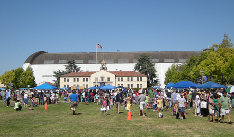 Crowds at Moon Fest; Lunar Science Institute in semi-background; Hangar One in background